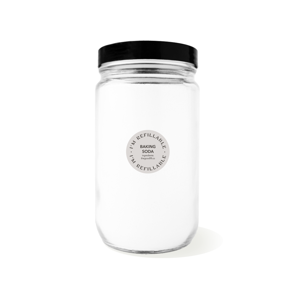 a clear glass 32oz refill mason jar that is filled with white baking soda and has a black recyclable aluminum screw on lid.