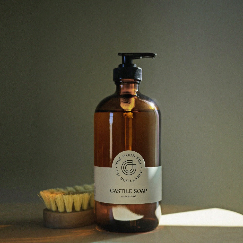 zero waste castile soap refills in a refillable glass amber bottle