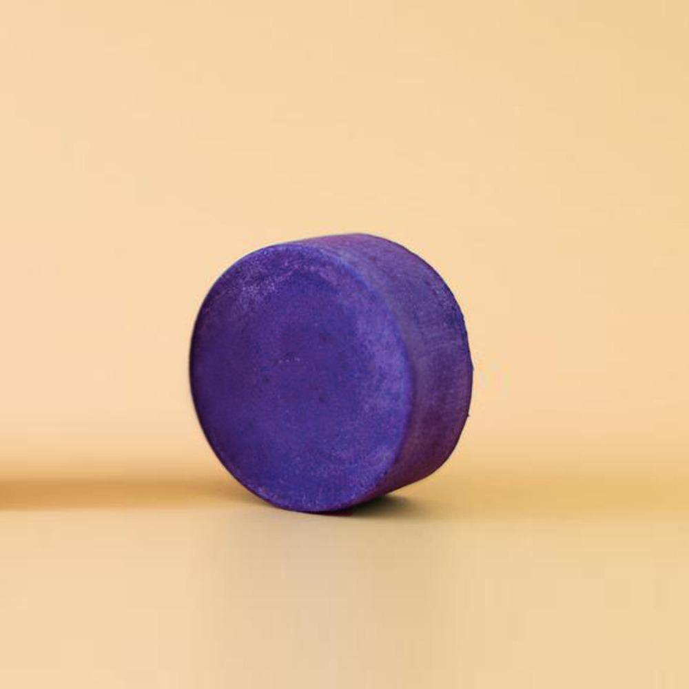 zero waste conditioner bar. The bar is a round deep purple toner conditioner bar.