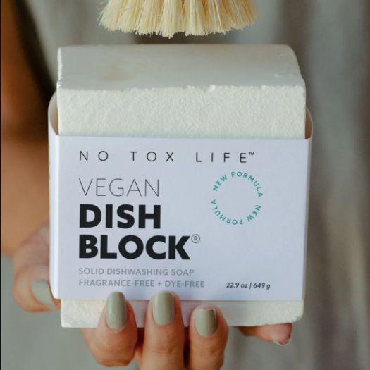 hand holding an extra large white dish washing block.