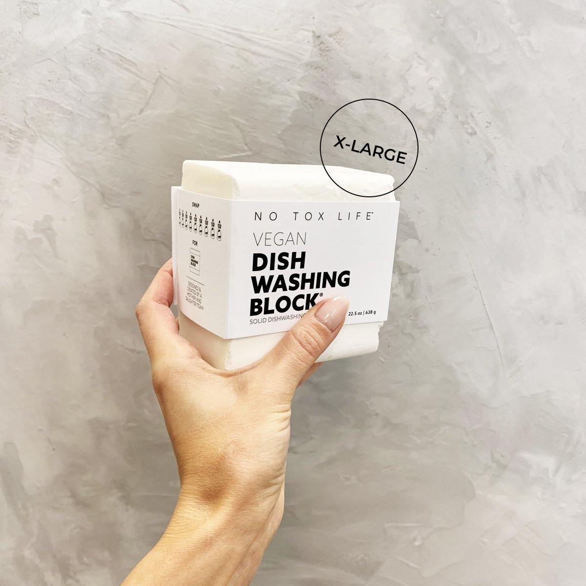 hand holding an extra large white dish washing block.