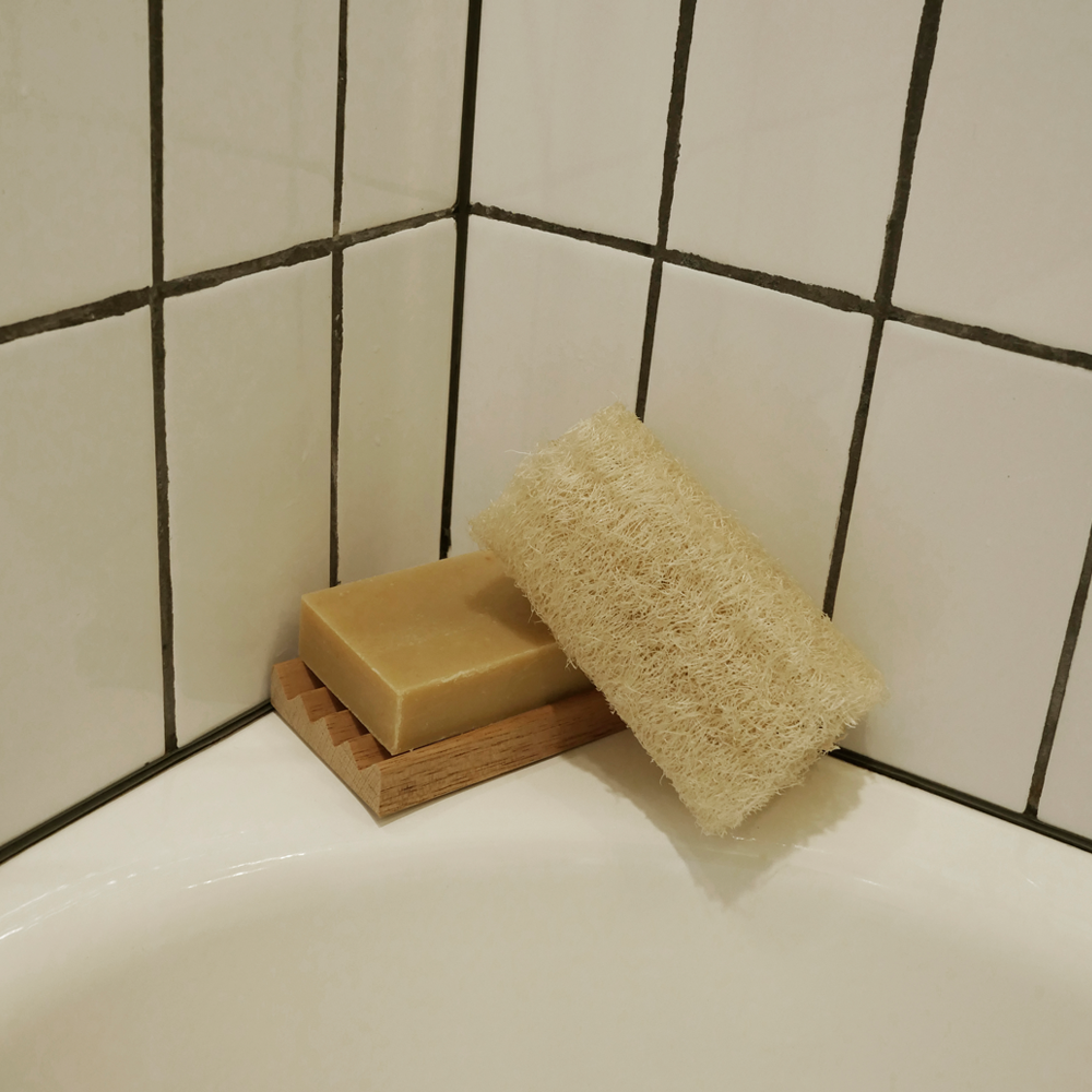 natural loofah sponge sitting next to a bar of soap