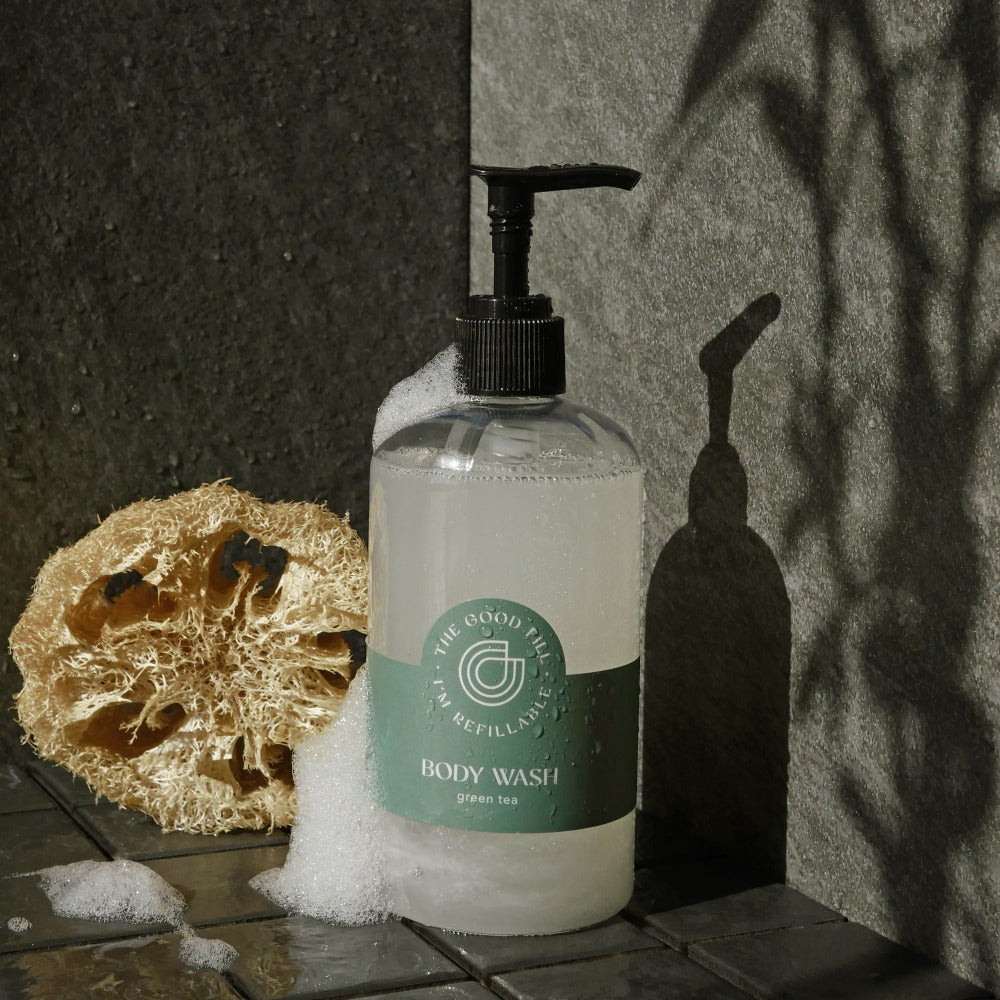 Green tea body wash refills in a zero waste recycled plastic pump bottle with a natural loofah