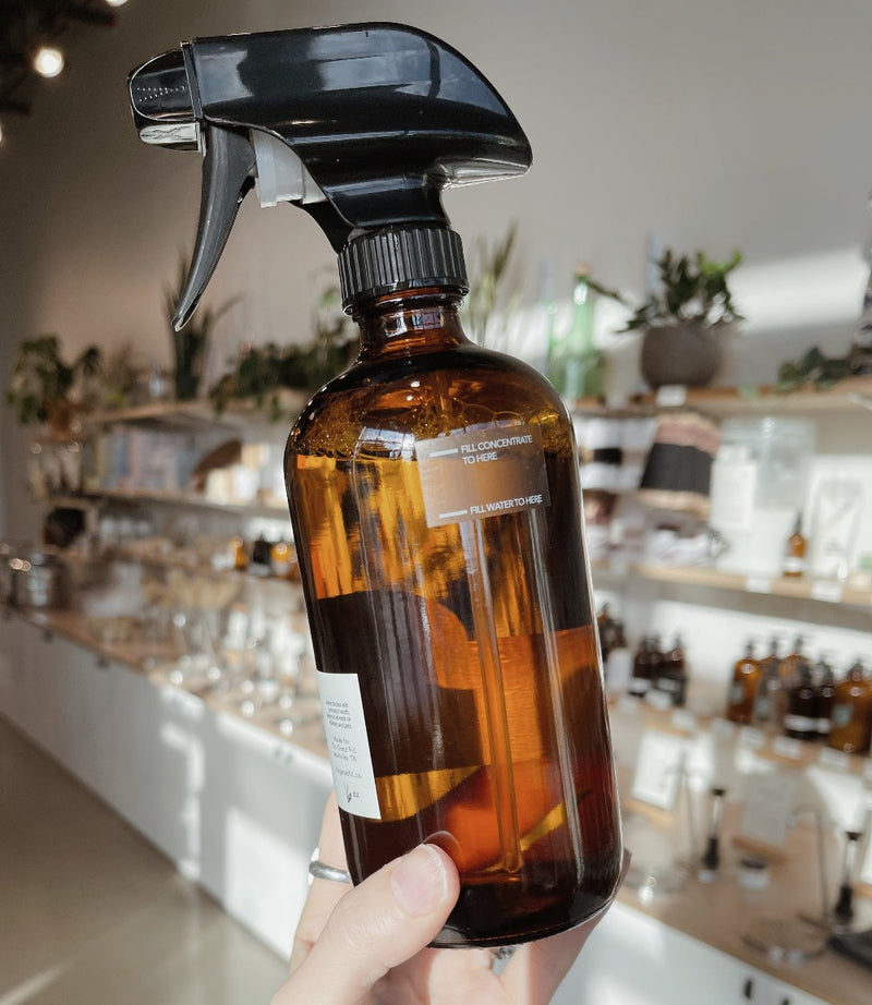 Refillable Glass Cleaner in a glass amber spray bottle with zero waste glass concentrate