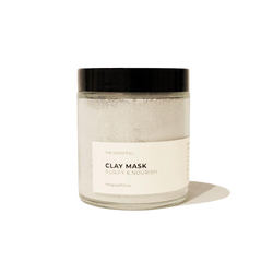 4oz. re-usable clear Good Fill glass jar filled with a light grey clay mask powder. The lid is a black twist-on lid.