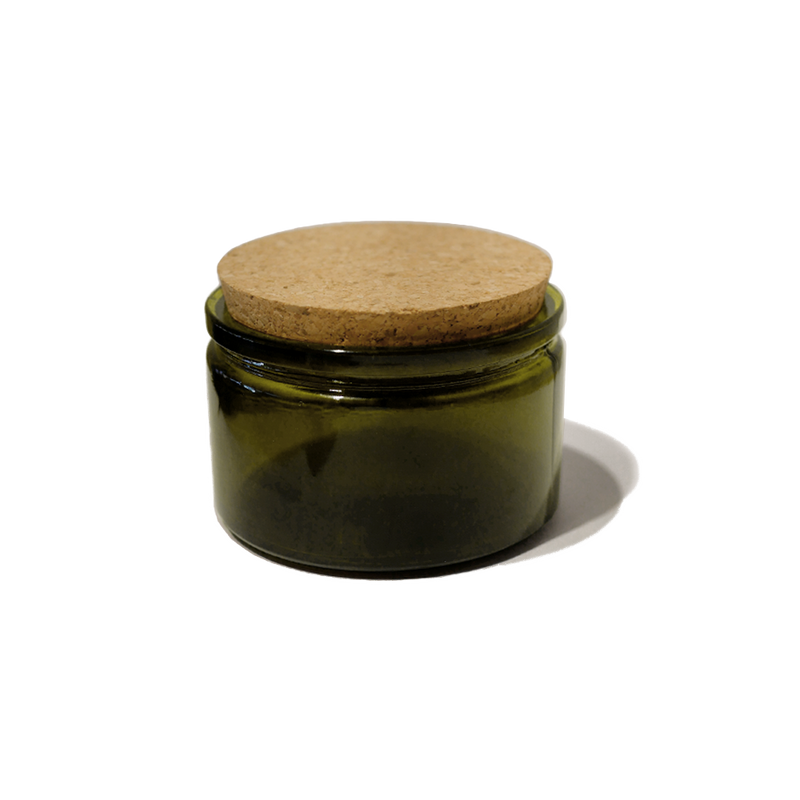 4oz. round recycled glass jar with a cork lid top. The jar is round and painted a dark olive green color.