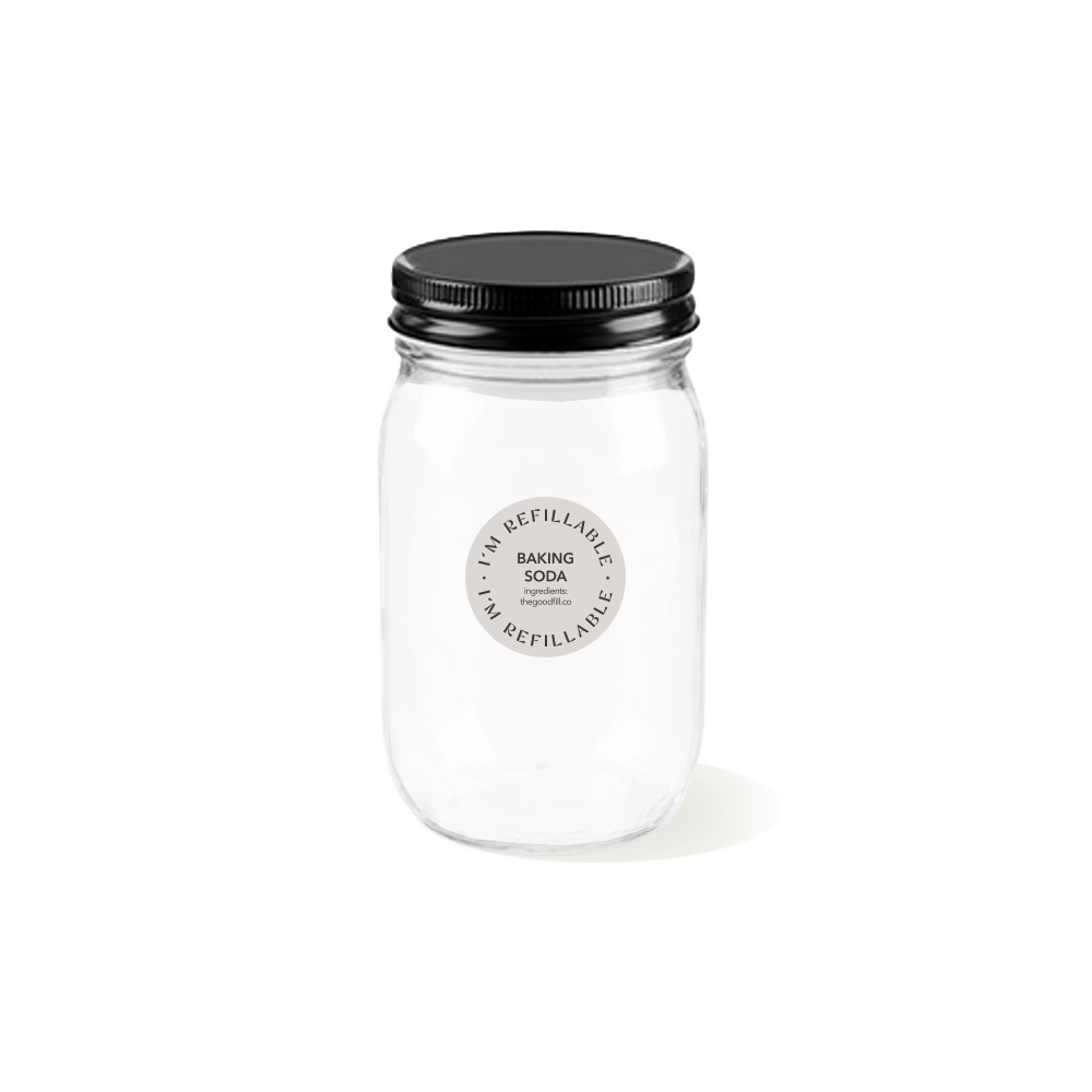 a clear glass 16oz refill mason jar that is filled with white baking soda and has a black recyclable aluminum screw on lid.