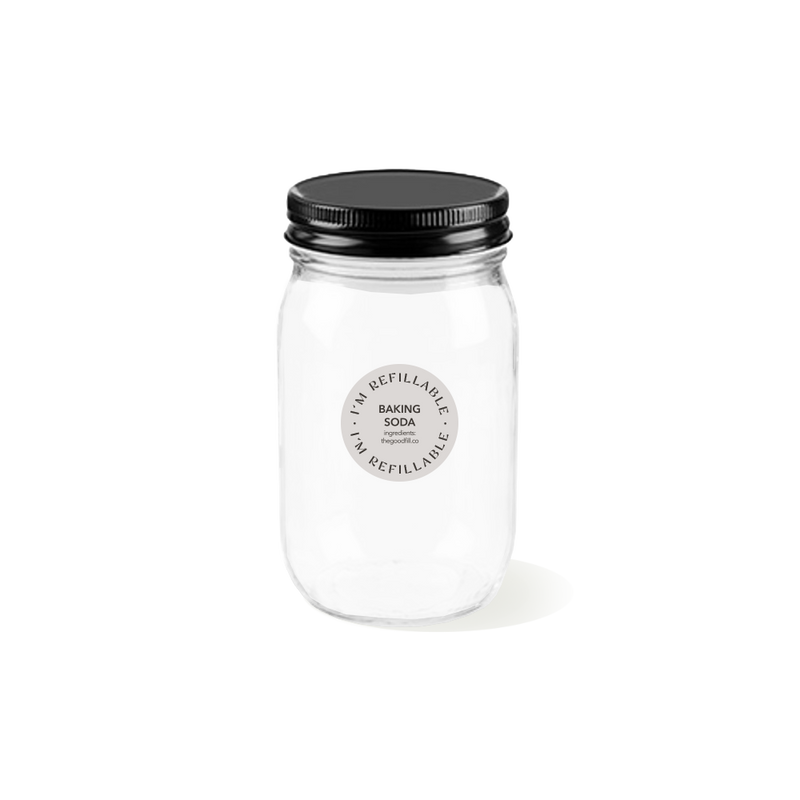 a clear glass 16oz refill mason jar that is filled with white baking soda and has a black recyclable aluminum screw on lid.