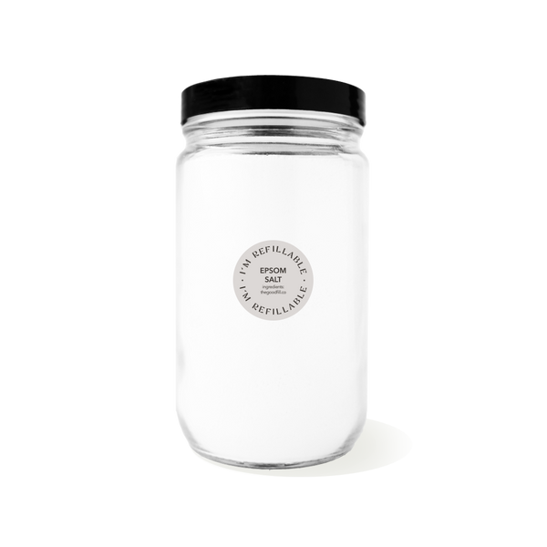 a clear glass 32oz refill mason jar that is filled with epsom salt and has a black recyclable aluminum screw on lid.