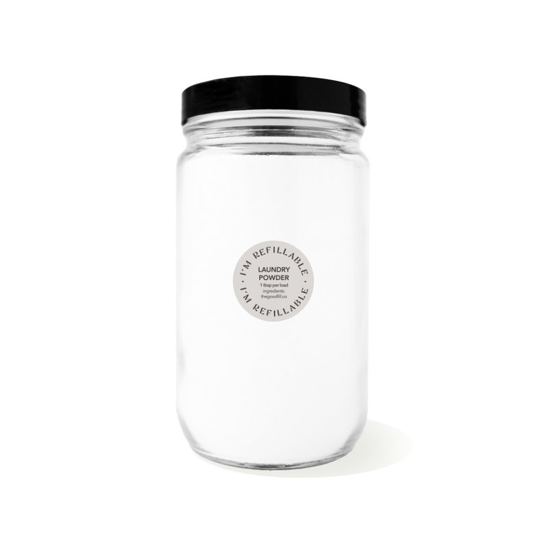 clear glass 32oz refill mason jar that is filled with white laundry powder and has a black recyclable aluminum screw on lid.