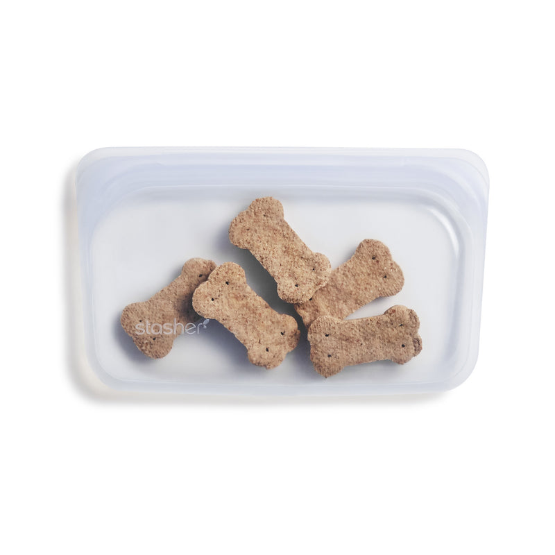 a reusable, clear, snack sized stasher bag. The bag is holding dog treats.