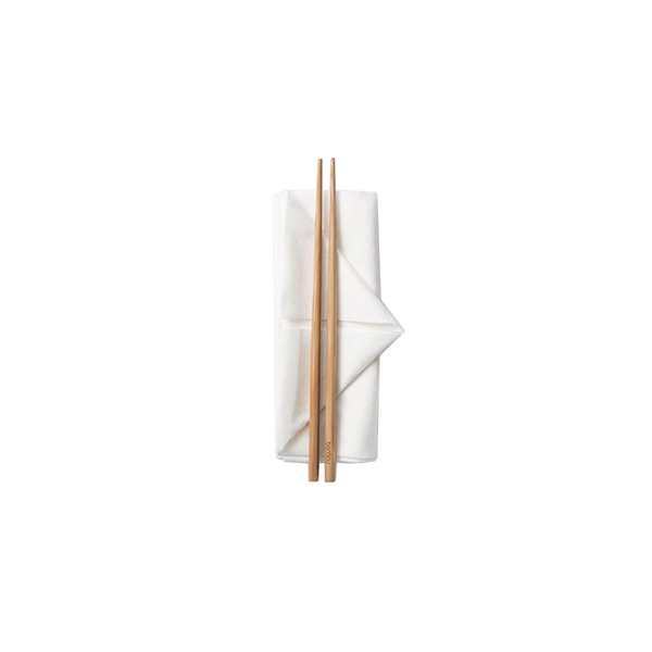 a pair of reusable natural brown bamboo chopsticks sitting on a neatly folded white napkin.