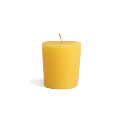 Yellow all natural beeswax votive candle for zero waste candle refills.