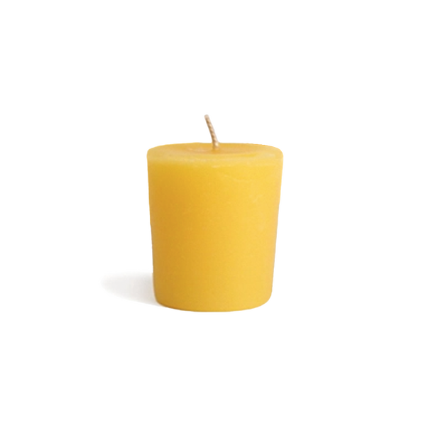 Yellow all natural beeswax votive candle for zero waste candle refills.