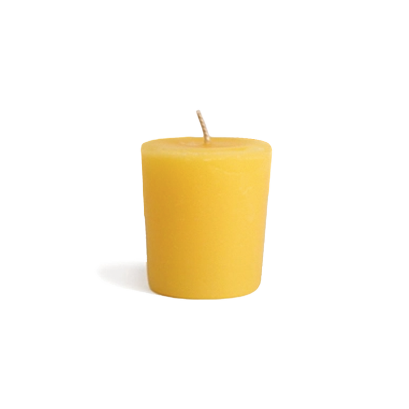 Yellow all natural beeswax votive candle for zero waste candle refills.