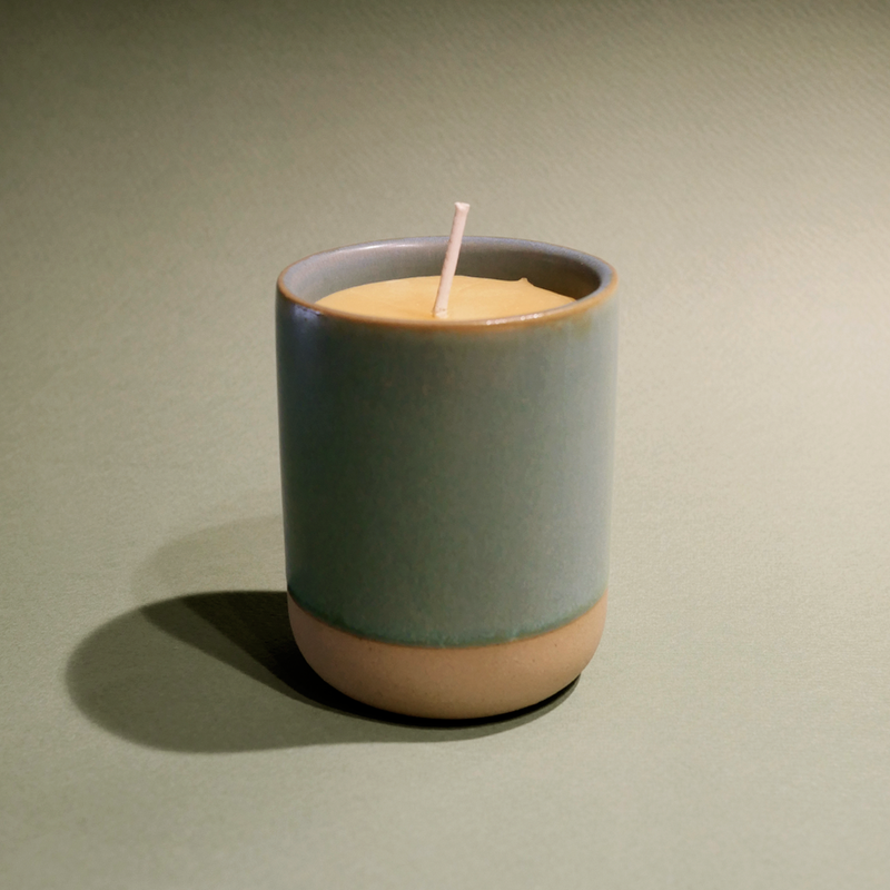 All natural beeswax candle in a stone ware vase.