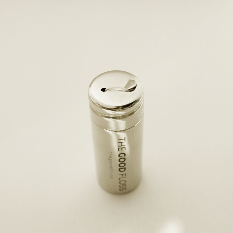 The Good Fill refillable dental floss in a stainless steel container.